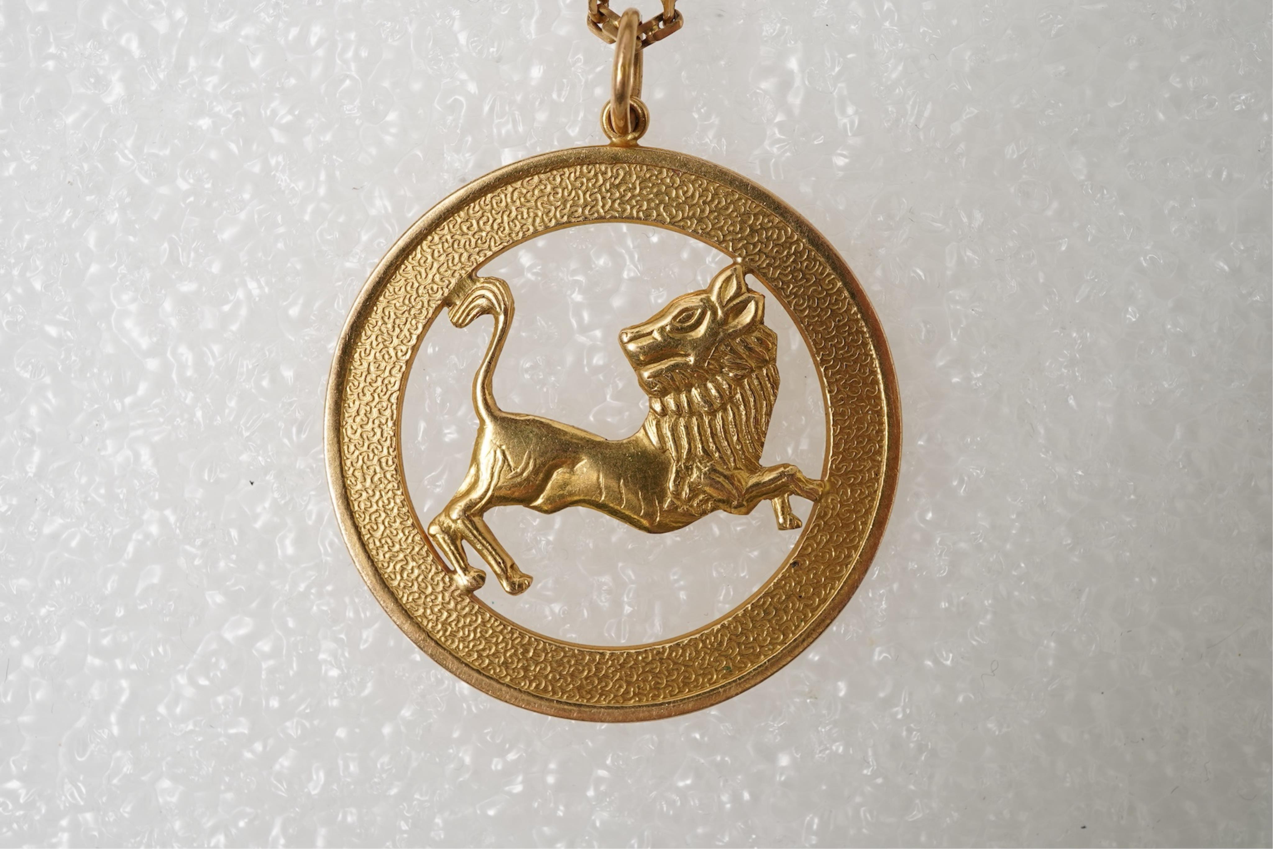 A gold zodiac pendant, mid 20th century